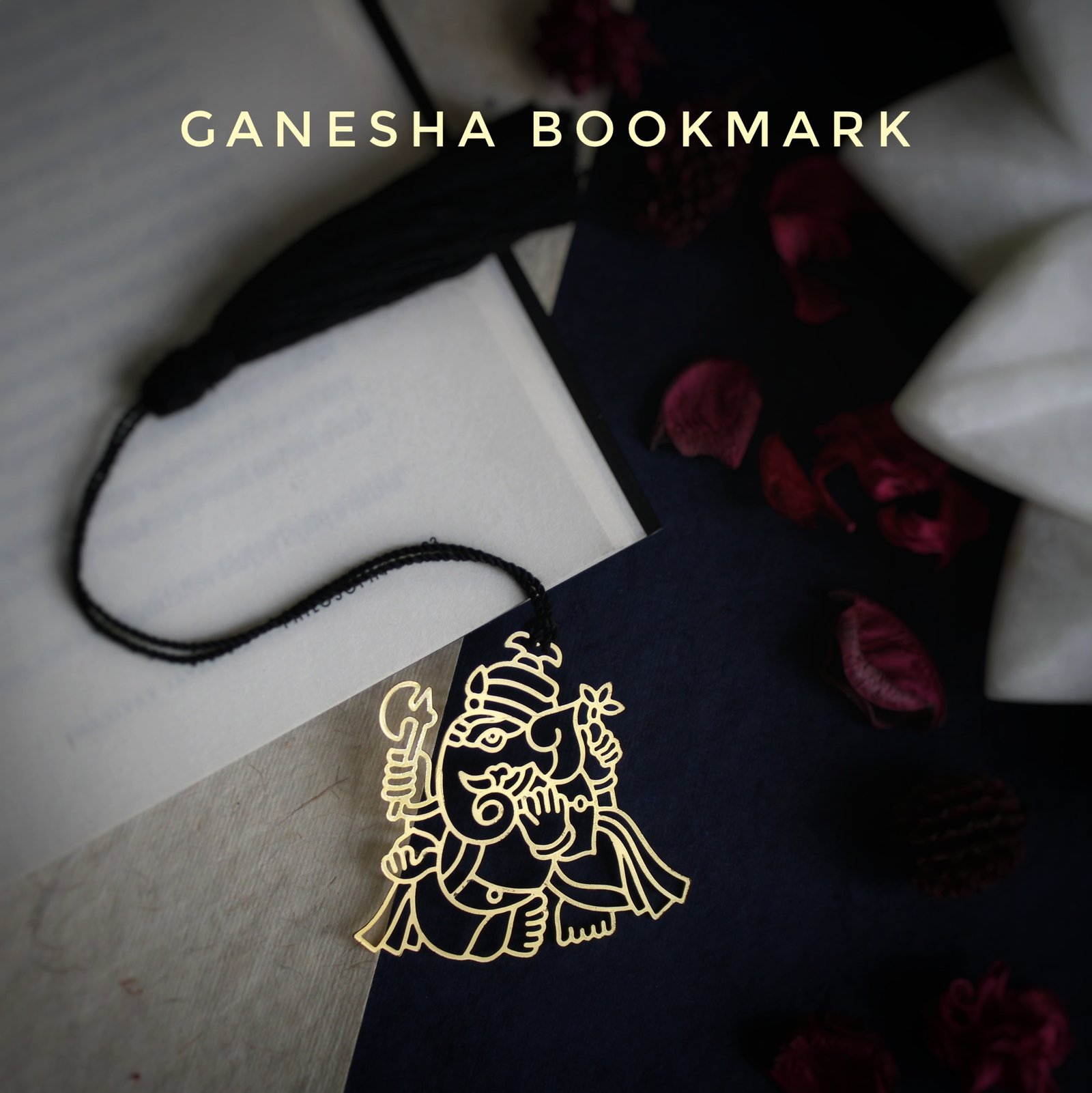 Elephantaa Ganesha brass metal bookmark with intricate design on an open book, perfect for spiritual gifts.