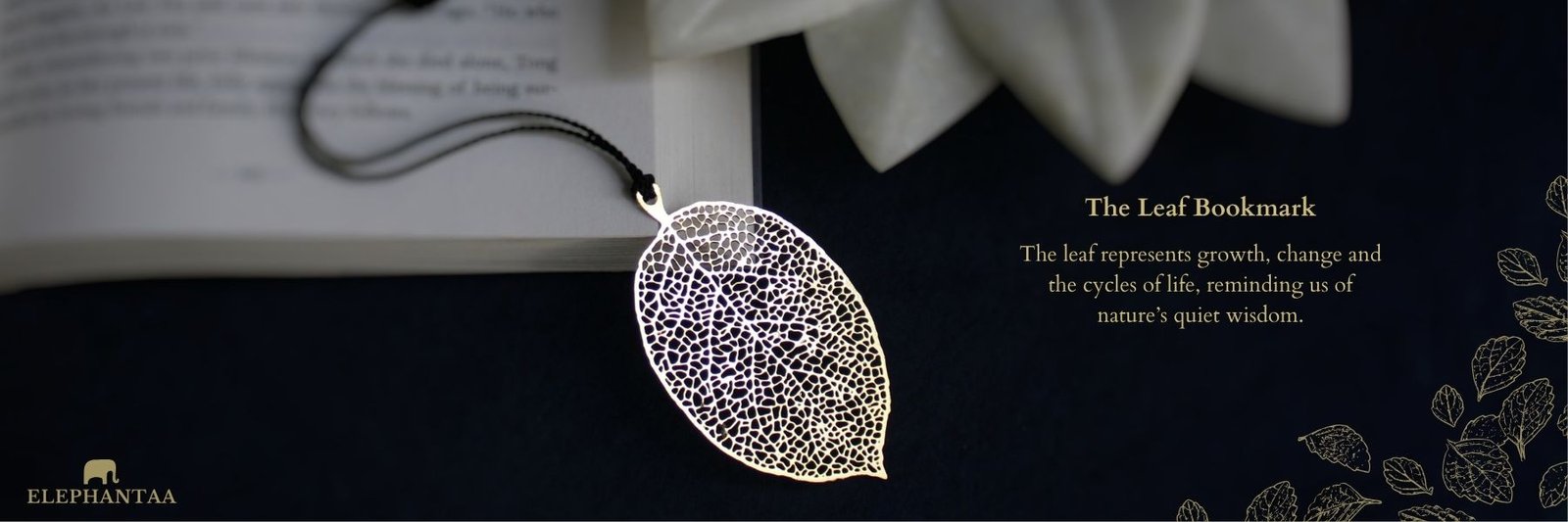 Elephantaa brass metal leaf bookmark on an open book, symbolizing growth and nature's wisdom.