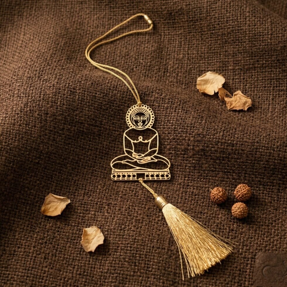 Brass Mahavir hanging decor on rustic wooden background with tassel, Jain home decor, spiritual hanging ornament