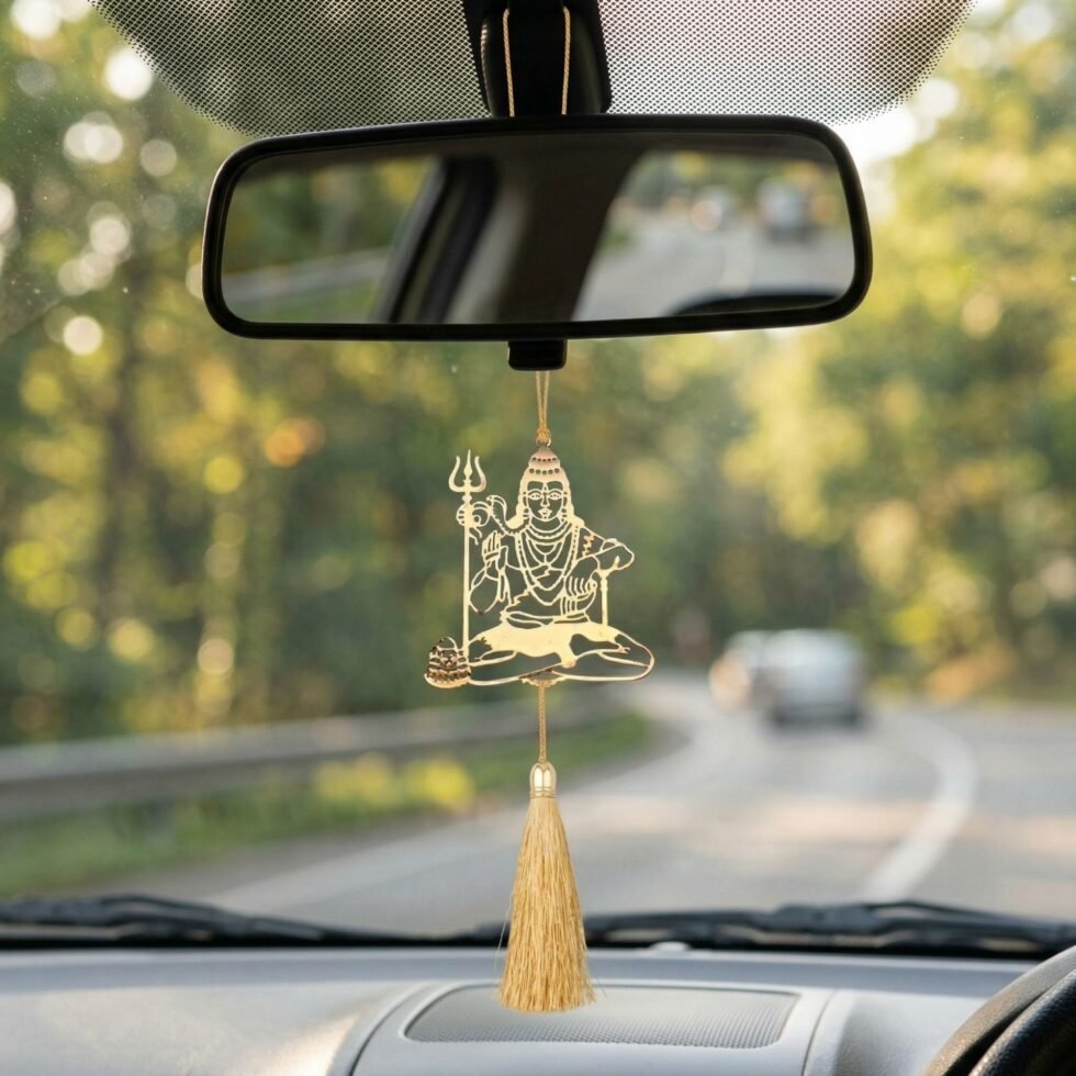 Shiva hanging decor inside car rear view mirror Mahadev brass ornament driving road background