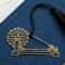 Charkha brass bookmark on blue book with khadi thread spool, Indian heritage inspired gift