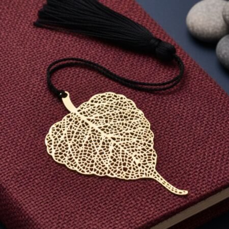 Bodhi leaf brass bookmark with stones on red book aesthetic setup