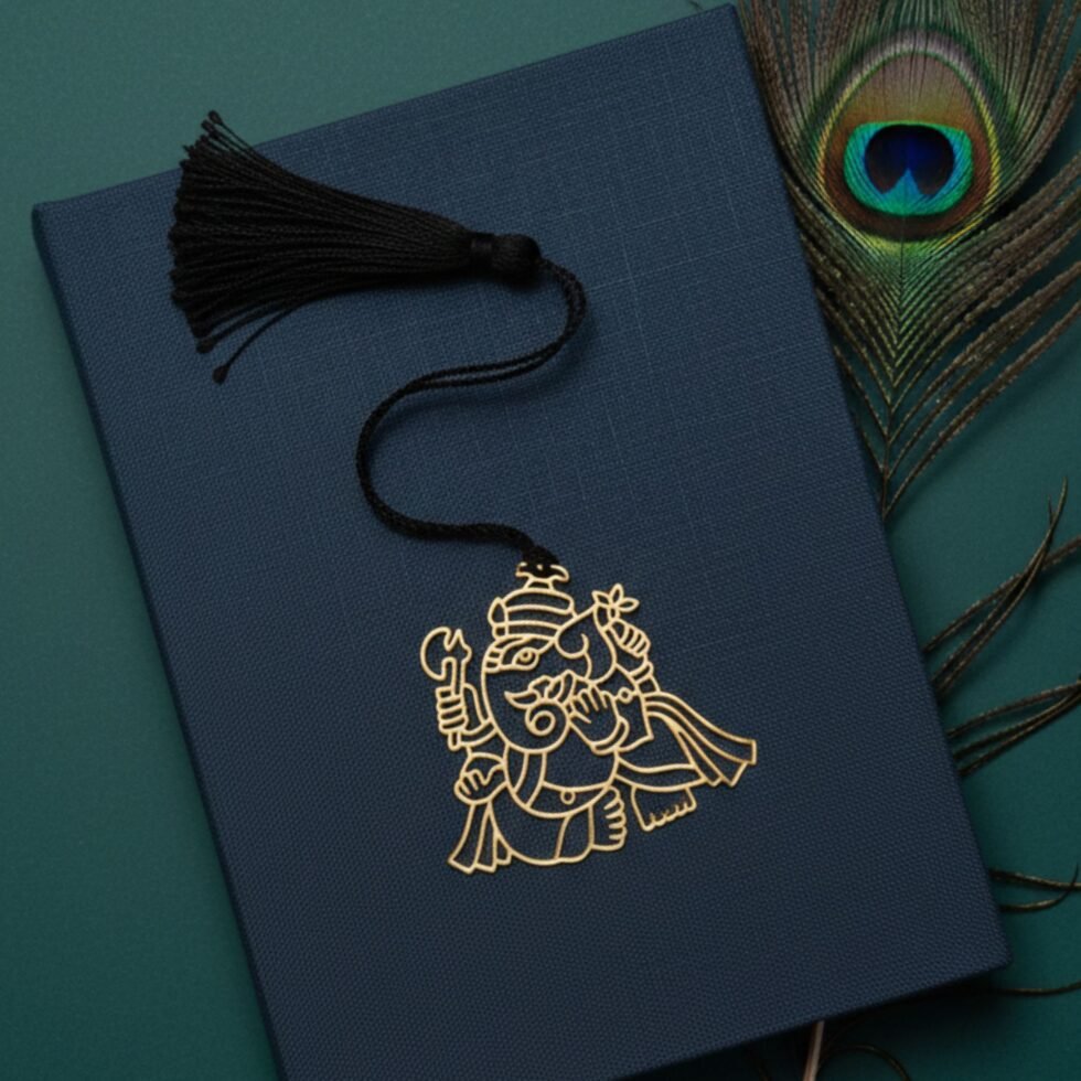 Ganesha brass bookmark on teal book with peacock feather premium Indian gift spiritual bookmark