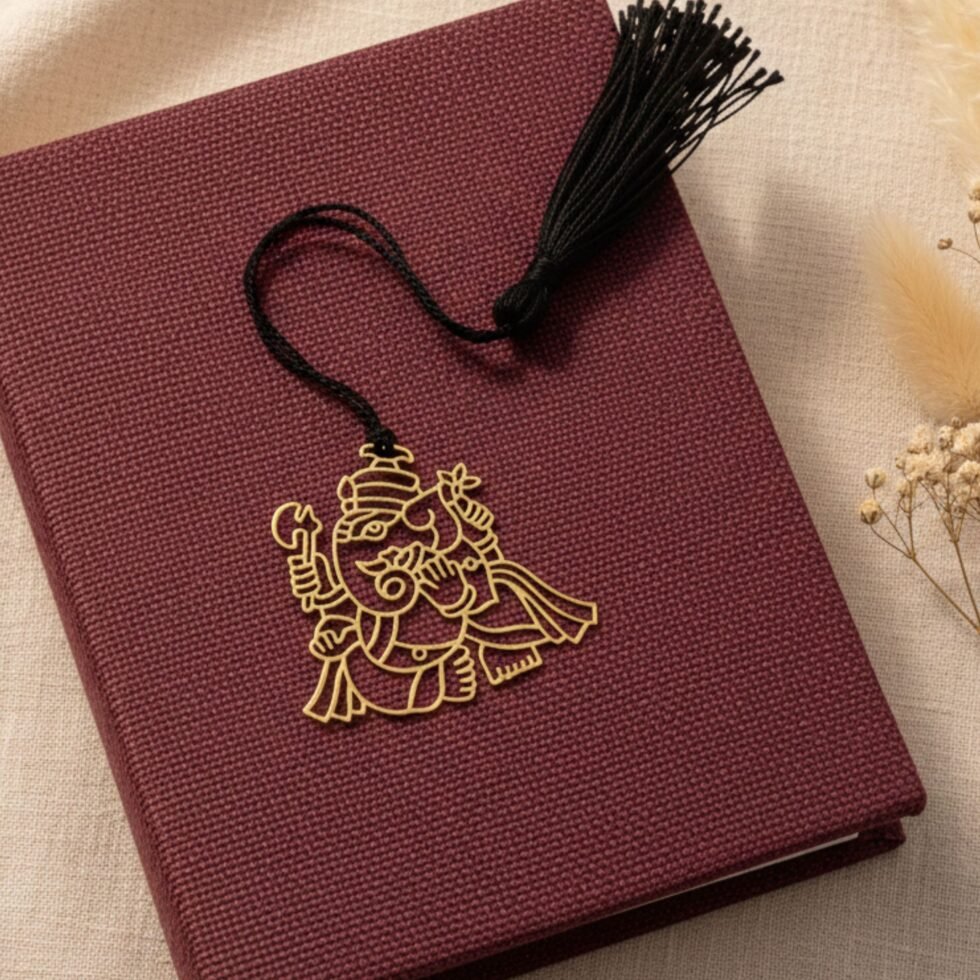 Ganesha brass bookmark angled on maroon book black tassel unique gift Indian gifts