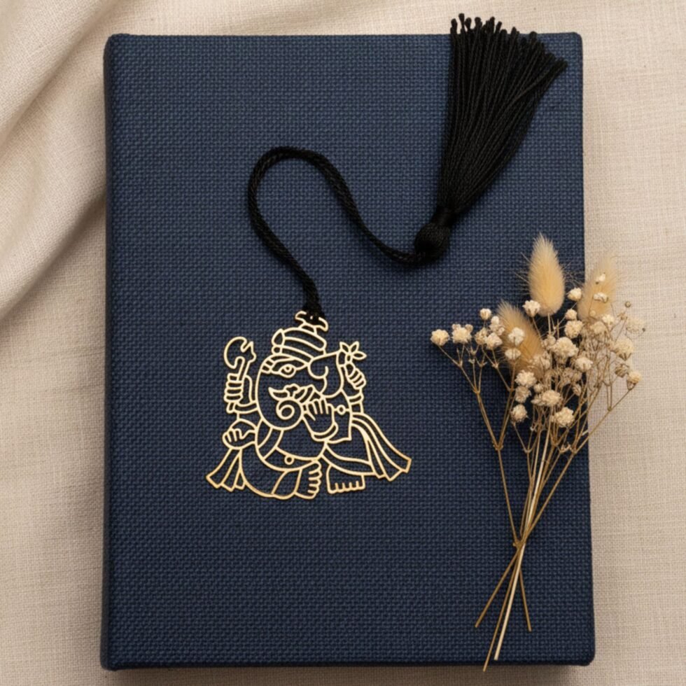 Ganesha brass bookmark on navy book with dried flowers elegant spiritual gift Indian gifts
