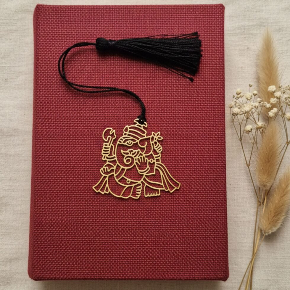 Ganesha brass bookmark on maroon book with dried flowers spiritual gift Indian gifts