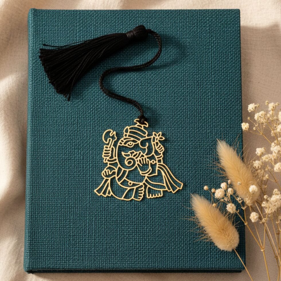 Ganesha brass bookmark on teal book minimal aesthetic unique gift Indian gifts