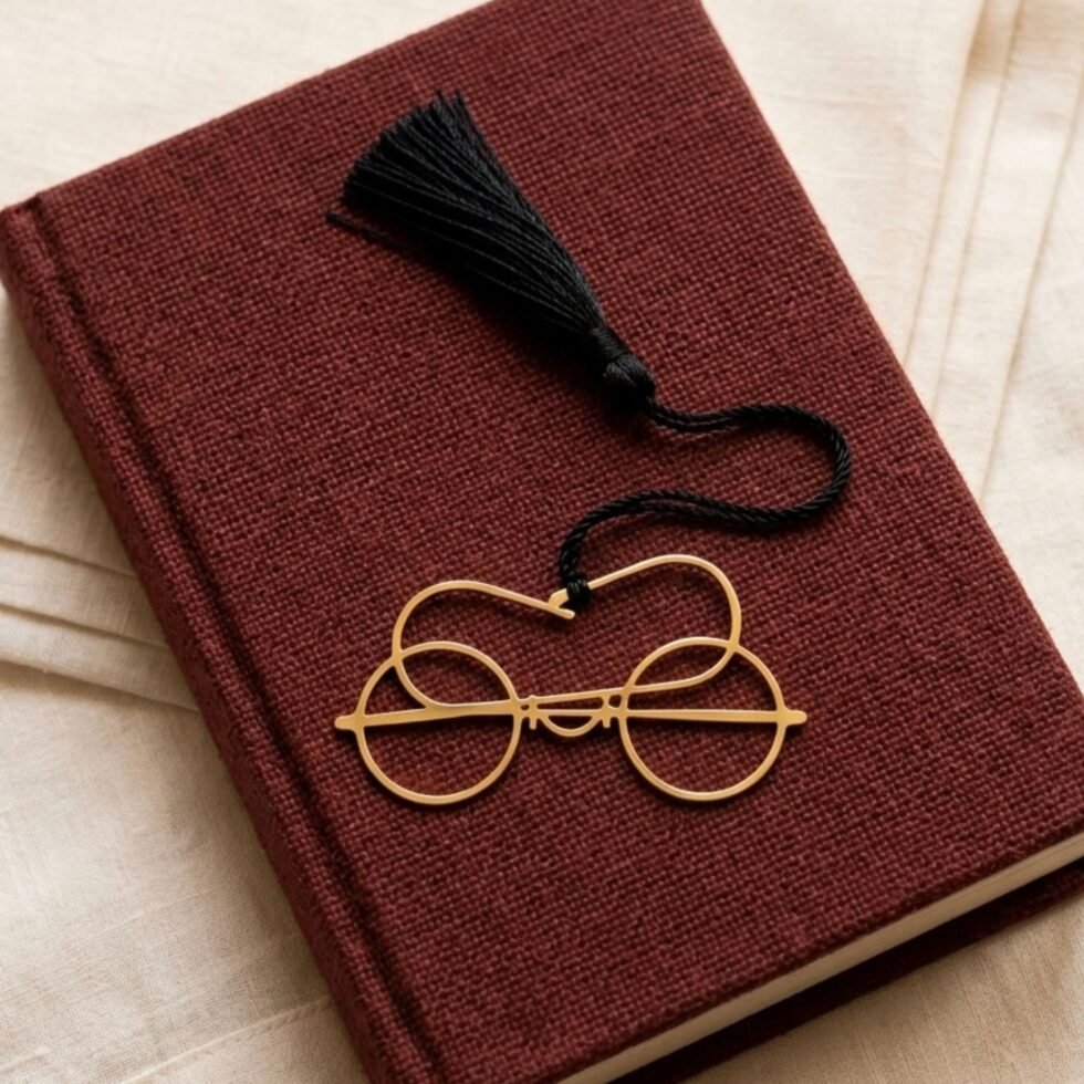 Gold plated Gandhi glasses bookmark with black tassel on maroon jute fabric book, unique Indian gift for readers and book lovers